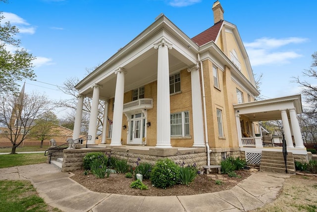 exterior space with a porch and a balcony