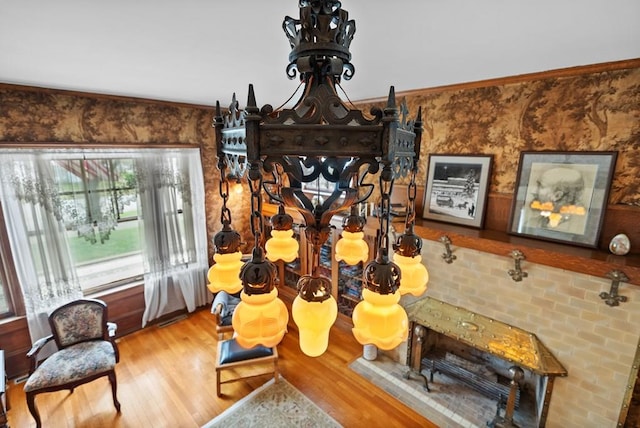 living area with hardwood / wood-style flooring and ornamental molding