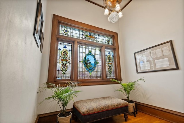 interior space featuring wood-type flooring and a notable chandelier