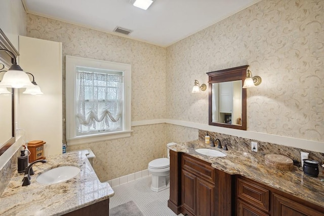 bathroom with tile patterned floors, vanity, and toilet