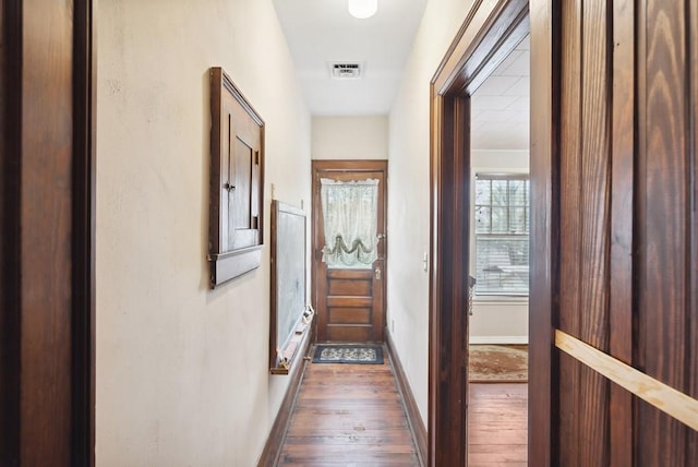 hallway with dark hardwood / wood-style floors