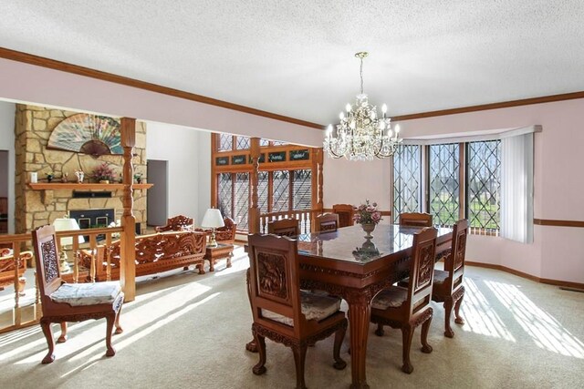 carpeted dining room featuring a textured ceiling, crown molding, a chandelier, and a fireplace