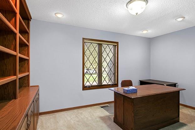 home office featuring a textured ceiling and light carpet