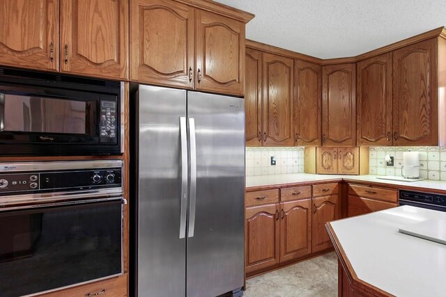 kitchen featuring black appliances and decorative backsplash