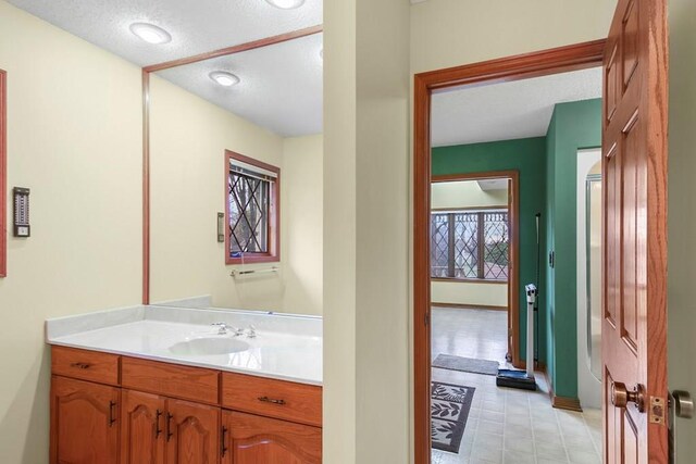 bathroom featuring vanity and a textured ceiling