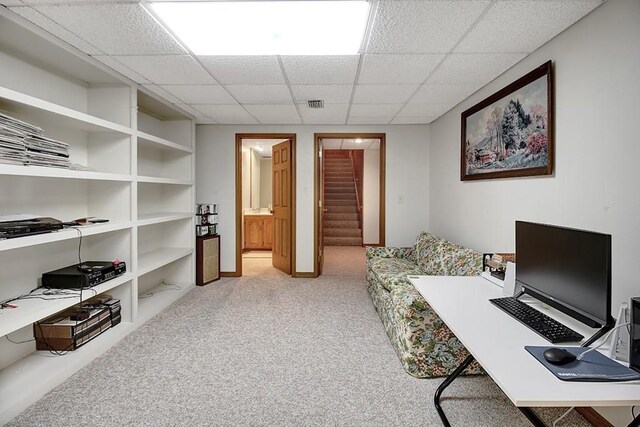 carpeted office featuring a drop ceiling