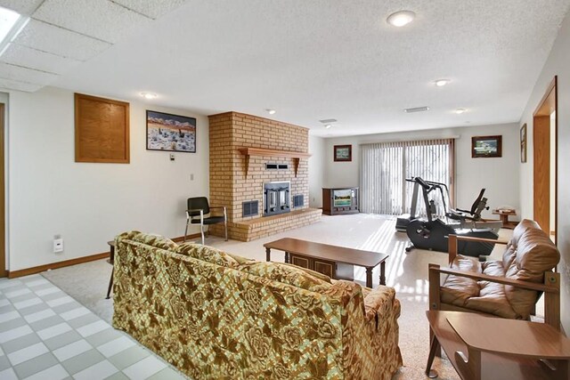 living room featuring a textured ceiling, carpet flooring, and a brick fireplace