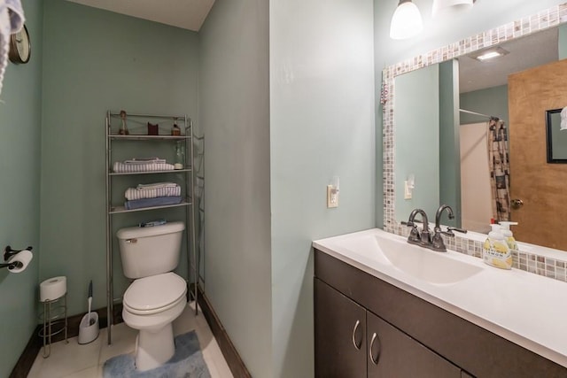 bathroom with tile flooring, oversized vanity, and toilet