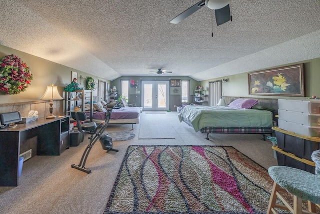 carpeted bedroom featuring a textured ceiling, lofted ceiling, and ceiling fan