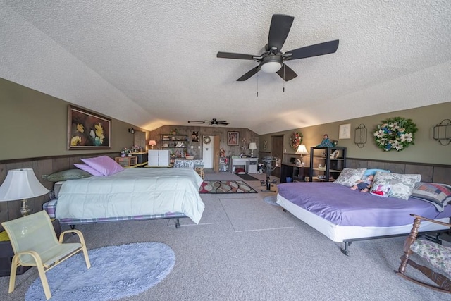 bedroom featuring vaulted ceiling, ceiling fan, a textured ceiling, and carpet floors