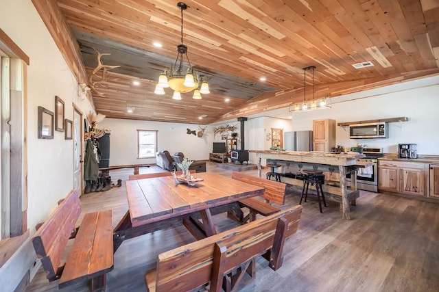 dining area with hardwood / wood-style flooring and wood ceiling