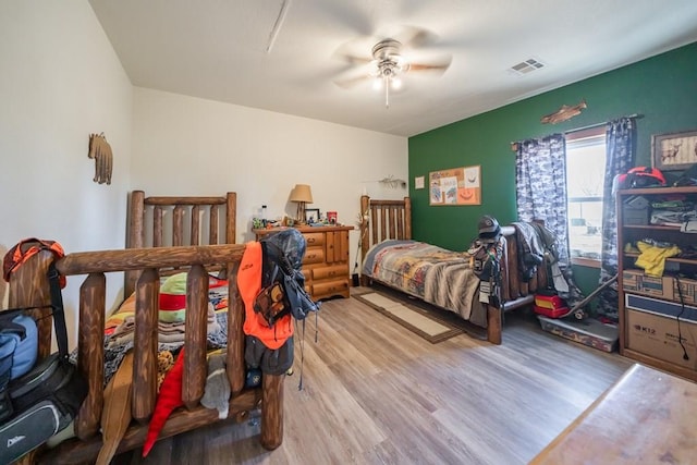 bedroom with ceiling fan and hardwood / wood-style flooring