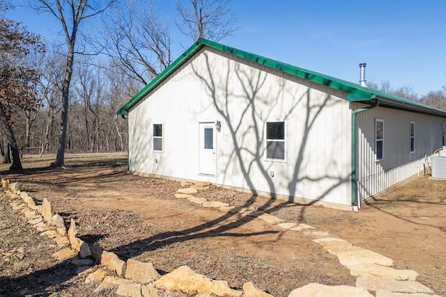 view of side of property with central air condition unit