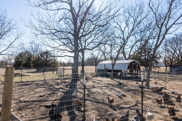 view of yard featuring a rural view and an outdoor structure