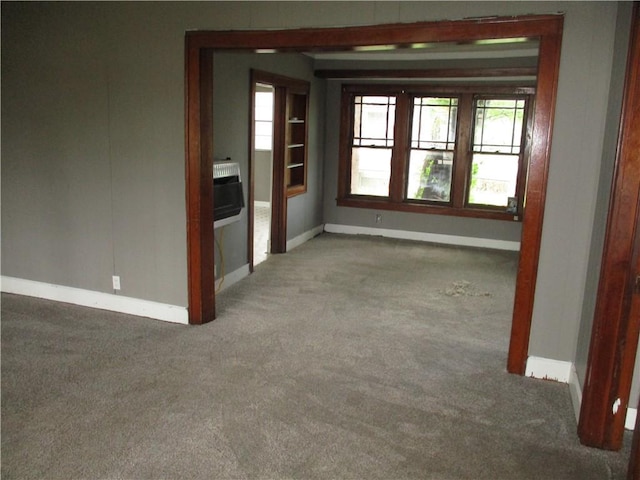 544 W Olive, Columbus, KS 66725 - spare room featuring carpet flooring, baseboards, and heating unit