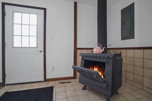 tiled foyer entrance featuring a fireplace, electric panel, and tile walls