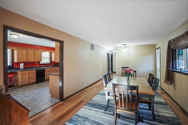 dining space featuring light hardwood / wood-style floors and sink