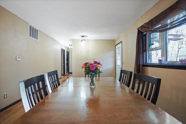 dining room with wood-type flooring