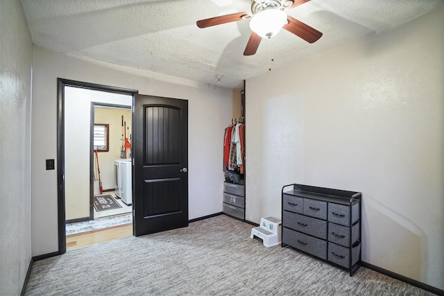 bedroom featuring carpet flooring, ceiling fan, and a textured ceiling