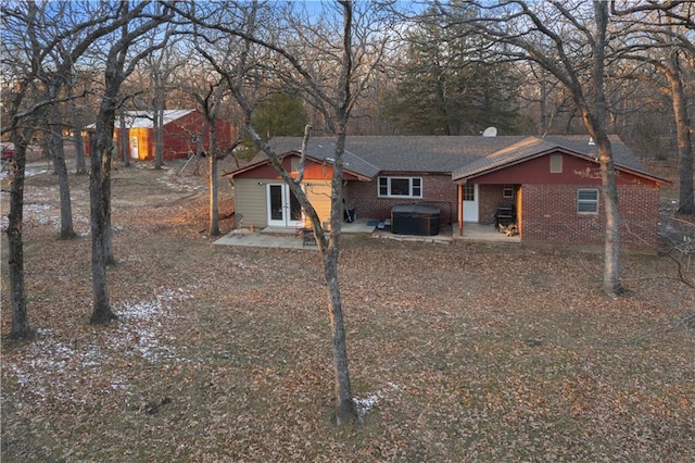 view of front of home featuring french doors, a patio, and a hot tub