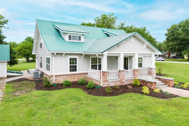 view of front of home featuring central AC unit, a front lawn, and covered porch