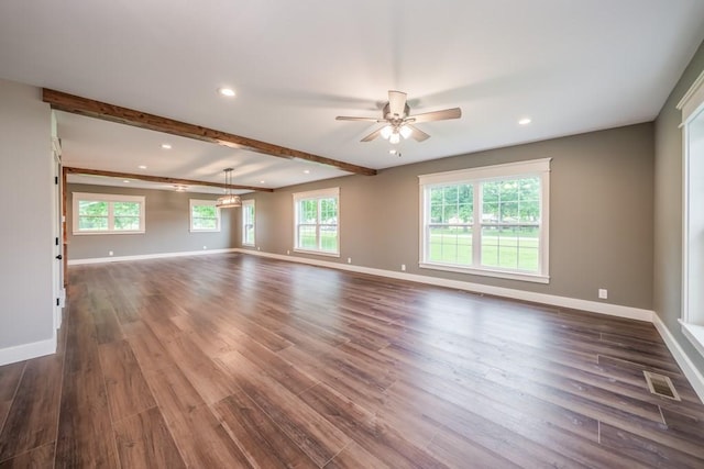 unfurnished living room featuring a healthy amount of sunlight, ceiling fan, and dark hardwood / wood-style flooring