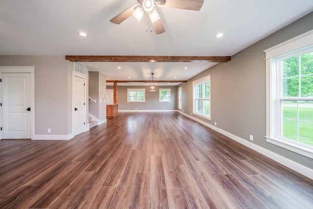 unfurnished living room with dark hardwood / wood-style flooring, a healthy amount of sunlight, and ceiling fan