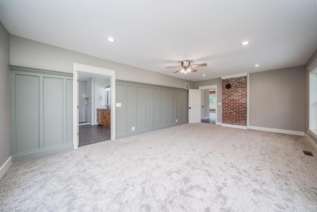 unfurnished bedroom featuring ensuite bathroom, ceiling fan, and carpet flooring