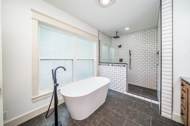 bathroom with vanity, plus walk in shower, and tile patterned floors