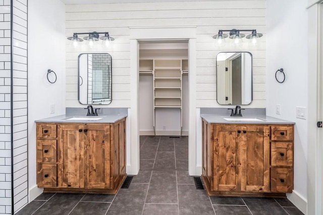 bathroom featuring wood walls, tile patterned flooring, and vanity