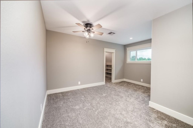 empty room featuring light carpet and ceiling fan