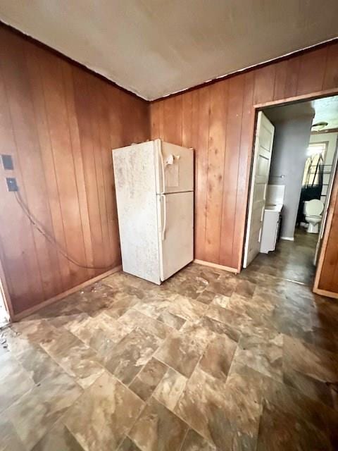 interior space featuring wooden walls and white refrigerator