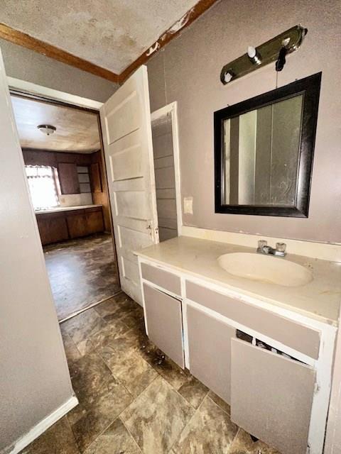 bathroom featuring crown molding and vanity