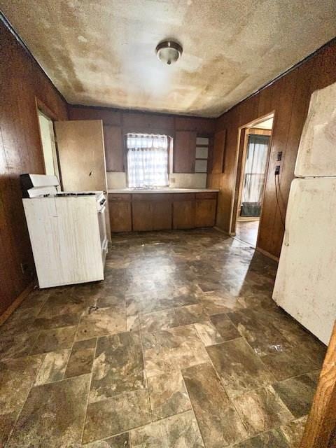 kitchen with wood walls and plenty of natural light