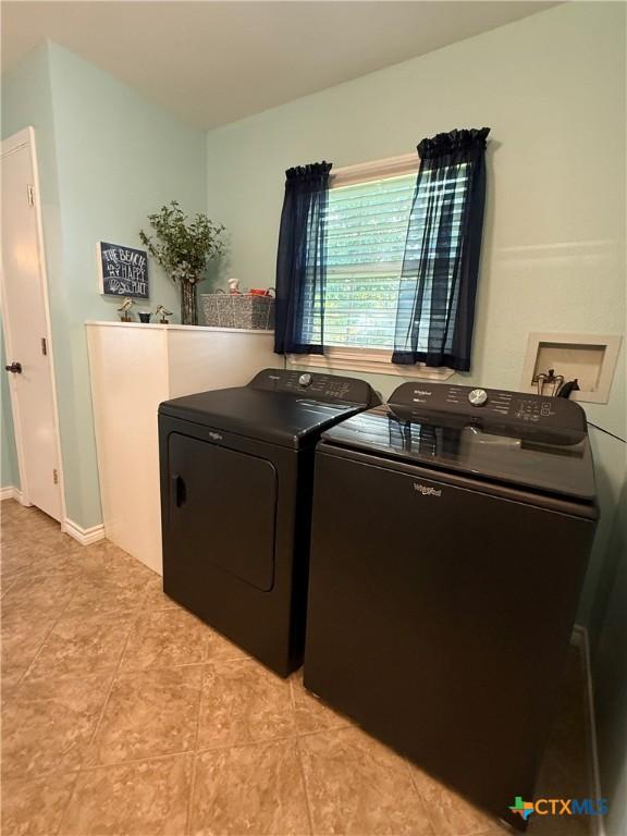 68 Silkstocking St, Port Lavaca, TX 77979 - laundry area featuring separate washer and dryer and light tile patterned floors