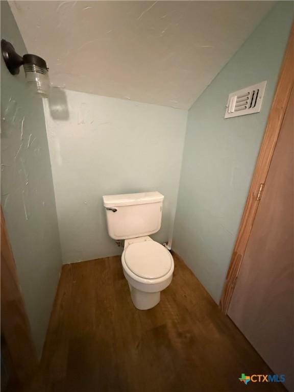 68 Silkstocking St, Port Lavaca, TX 77979 - bathroom featuring wood finished floors, lofted ceiling, toilet, and a shower