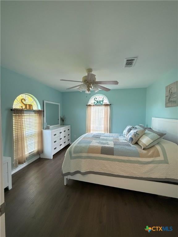 68 Silkstocking St, Port Lavaca, TX 77979 - bedroom with dark wood-style floors and ceiling fan