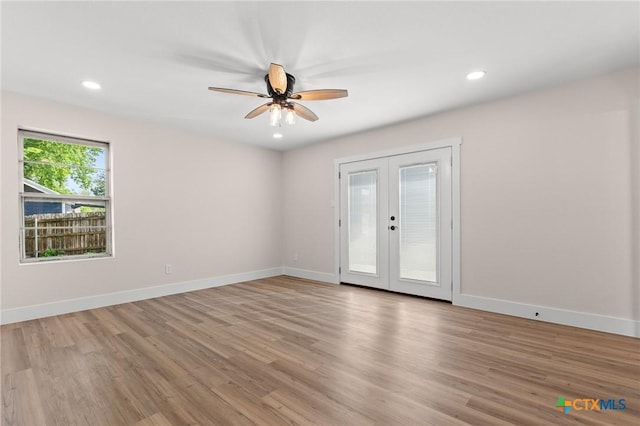 empty room featuring recessed lighting, a ceiling fan, french doors, and light wood-type flooring