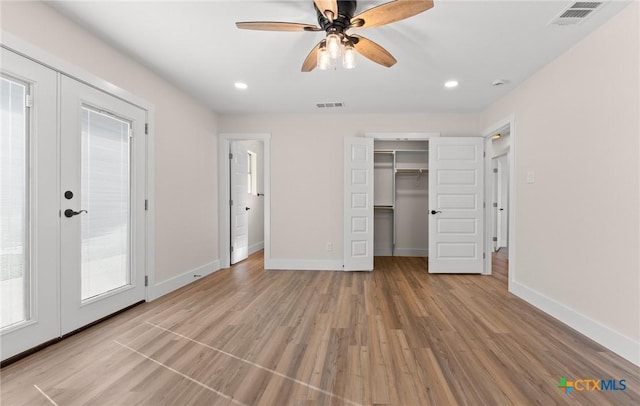 unfurnished bedroom featuring baseboards, visible vents, and light wood-type flooring