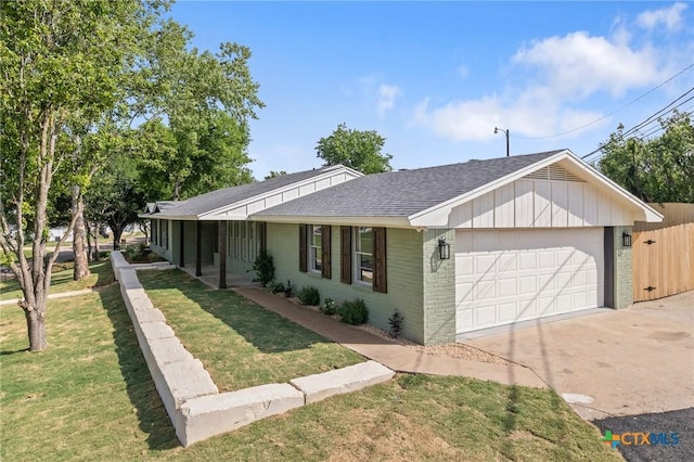 ranch-style house featuring driveway, a front yard, a garage, brick siding, and a shingled roof