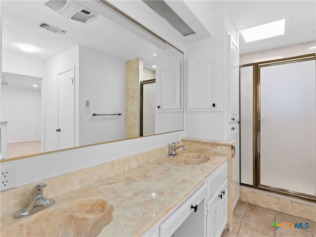 full bathroom with a sink, visible vents, and a shower stall