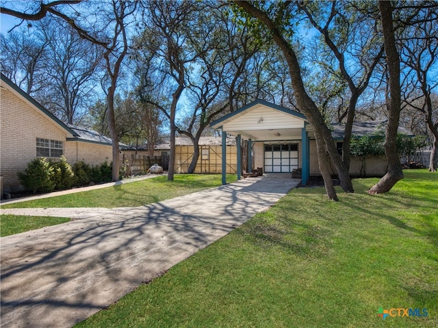 view of front of house with brick siding, a carport, fence, a garage, and a front lawn