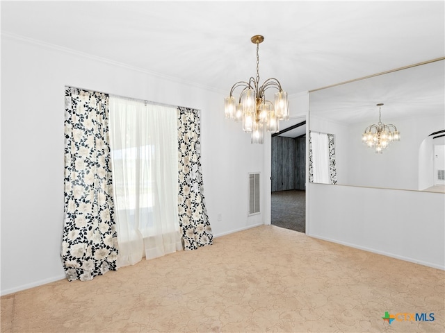 carpeted empty room featuring a chandelier, ornamental molding, visible vents, and baseboards