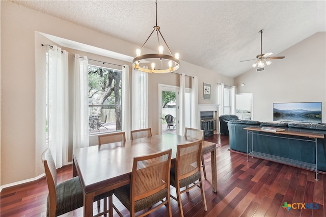 8302 Dove Valley Cv, Austin, TX 78729 - dining room with dark wood finished floors, vaulted ceiling, a chandelier, a textured ceiling, and ceiling fan