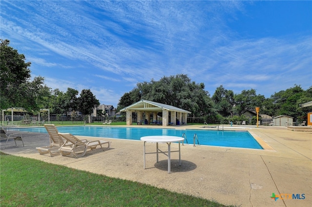 8302 Dove Valley Cv, Austin, TX 78729 - community pool featuring a gazebo, fence, a patio area, and view of wooded area