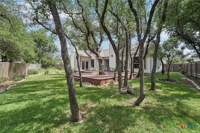 8302 Dove Valley Cv, Austin, TX 78729 - view of yard featuring a deck and french doors