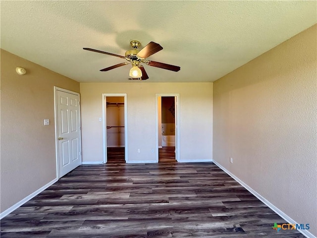 3807 Sunflower Dr, Killeen, TX 76542 - unfurnished bedroom featuring dark wood finished floors, a ceiling fan, a spacious closet, a closet, and a textured ceiling