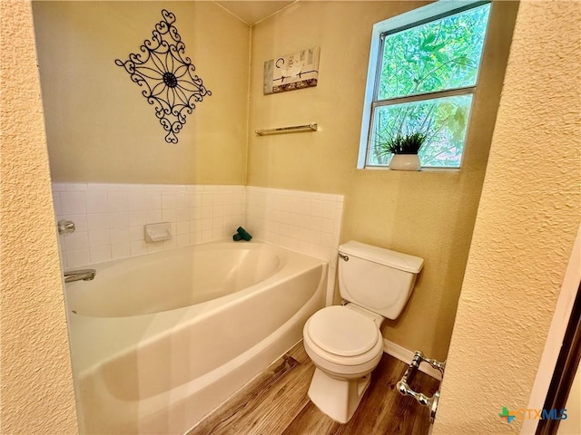 3807 Sunflower Dr, Killeen, TX 76542 - bathroom featuring a bath, wood finished floors, and a textured wall