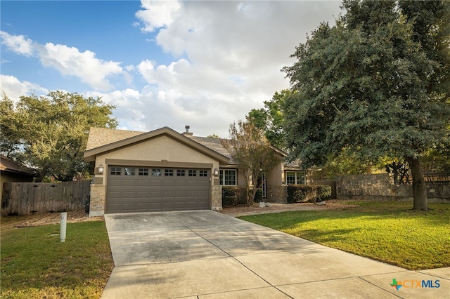 view of front of house with a garage and a front lawn