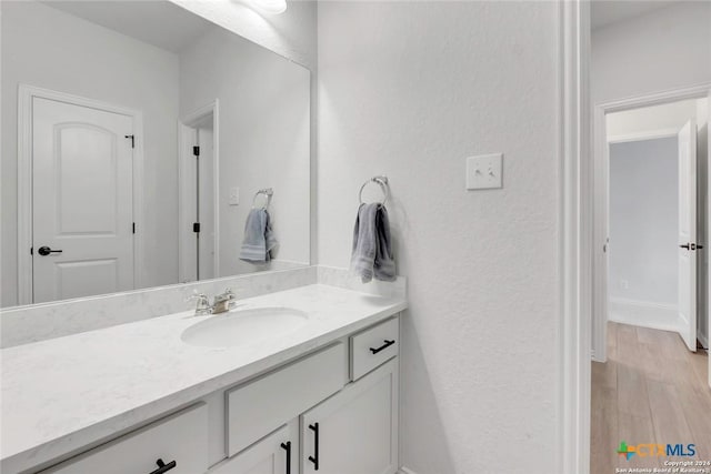 bathroom featuring hardwood / wood-style flooring and vanity